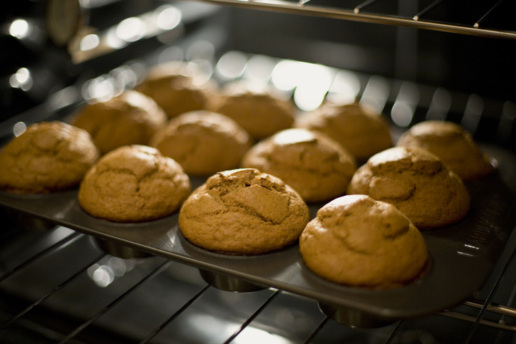 Muffins in a pan in an oven.