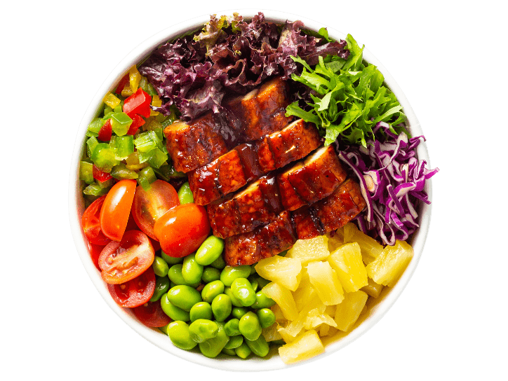 A bowl with a variety of vegetables and meat in it.