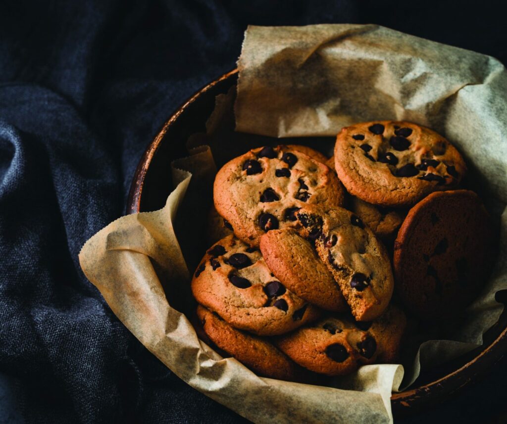 Chocolate chip cookies in a bowl on a table.