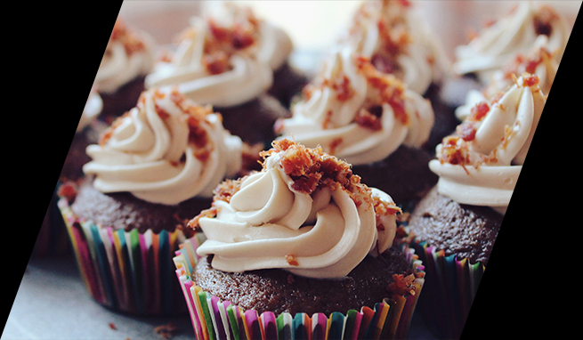 Chocolate cupcakes with bacon and icing.